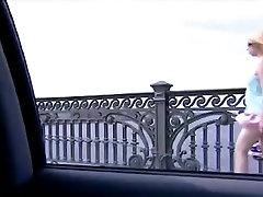 Upskirt done by a wind to a blonde babe walking across a bridge