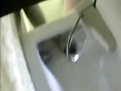 Spy device in a beach toilet watching girl pee