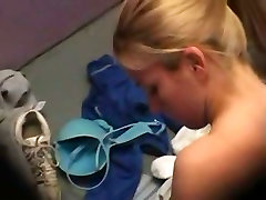 A sexy blonde is taking everything off for beach near a hidden camera in changing room