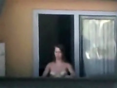 Sexy neighbor showing off her white tits in the window