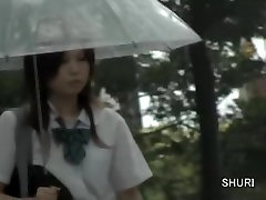 Asian schoolgirl gets street sharking on a rainy day.