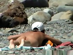 Small boobs nudist solo female squirting in the rocky beach