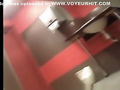 Teen and redhead in latex woman peeing in toilet