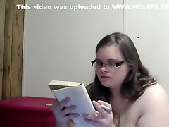 Nerdy girl smokes naked while reading in bed