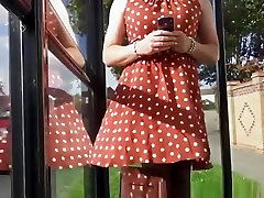 Wind lifts womans red dress exposing her