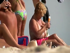 Gigantic mature tits on a beach