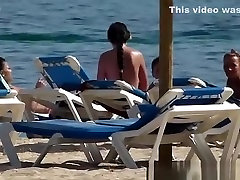 Pretty topless girls sunbathing on the beach