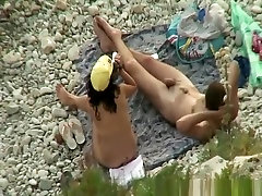 Man gropes her womans tits in beach