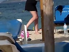 Girl on the beach dresses pants.