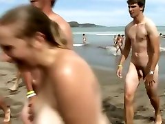 Huge group of nudists swim in the ocean