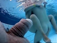 Naked women underwater at a melissa menginy resort pool