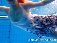 Cute Lucie is stripping underwater