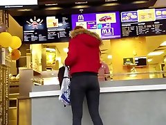 Redhead girl with round ass on the food court
