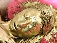 Girl in gold paint fucks herself ate bold rides Sybian