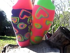 Beautiful vignette mom girl shows socks and bare feet outside