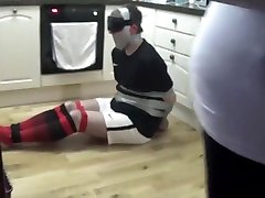 Footballer tied and taped tight on kitchen floor