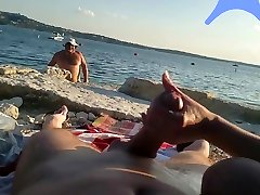 On a nude beach the wife stokes my cock while a gorop fug pron video watches