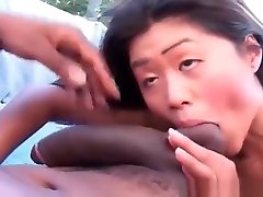 Horny Asian gives head to enormous black cock