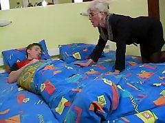 Mature with Silver Hair Glasses and Stockings Wakes the Boy
