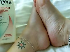 mature milf lotions up her sexy soft soles before bed for you