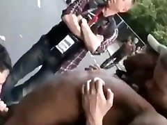 group of guys being very public at a street fair.