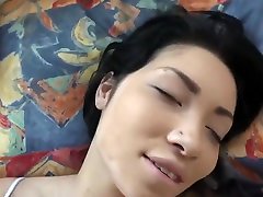 Horny brunette is moaning while getting fucked and enjoying while giving a footjob to her guy