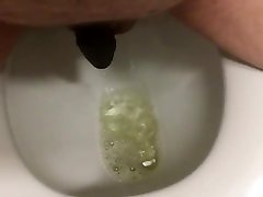 pissing while wearing silicone chastity device.