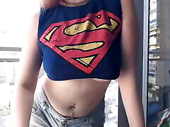 supergirl vêtue de seins clignotants sur le balcon