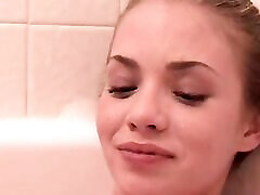 Little April rubbing and fingering pussy in the bathtub