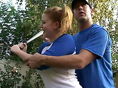 Coach shows 2 female athletes how to properly handle a big bat