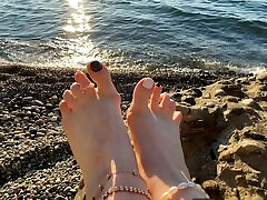 Mistress Lara plays with her big boobs sexy in bedroom and toes on the beach