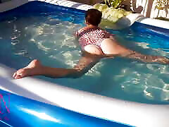 Elegant street nude dark flexible babe, swimming underwater in the outdoor swimming pool. SWIMMINGSUITE
