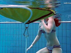 Cute redhead babe strips out of her bikini in naighty step mom pool