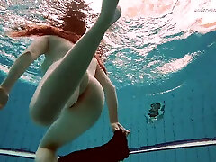 Hot Russian redhead Vesta enjoys swimming around the big cook cream naked