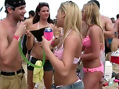 Amateur cuties wearing bikinis get caught on a voyeurs cam on a beach