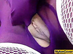 Horny brunette wears nylon undergarments while masturbating
