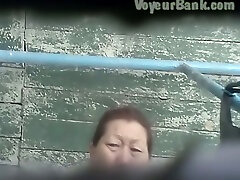 Hairy pussy of a mature Asian lady in the public creampie water sex room