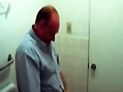 Chubby mature guy getting blowjob in the public restroom