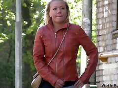 Blonde whore in leather jacket gets her pants wet with her own piss