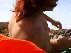 Chubby redhead wife and I on the nudist beach sunbathing