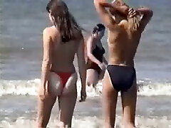 Two young blonde chicks walking on the orthar fuck beach topless
