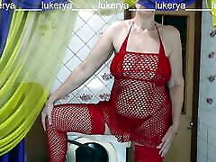 热家庭主妇Lukerya在她最喜欢的红色渔网装展示了她性感的身体，同时与球迷在厨房里调情