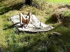 sweet laela cruz lies naked on the meadow and fingers her vagina in the sunshine