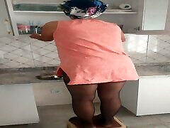 Mature suline six mom doing her daily chores in the kitchen