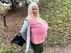 Blonde is flashing her big boobs in the outdoors
