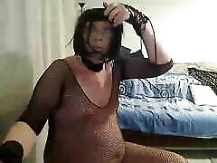 horny MILF tranny fondles and shows off for the camera in a silk blouse, black fishnet and high heels