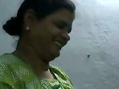 Mature and happy Indian aunty providing oily handjob on cam