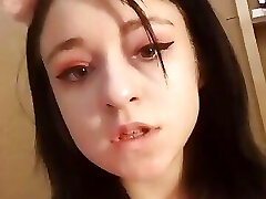 Daytime home striptease in a pinkish t-shirt and demonstrating off beautiful breasts. Close-up