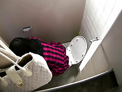 A woman who is bold and inviting in a closed room.