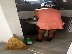 Mature woman in hijab cleans building in sexy dress